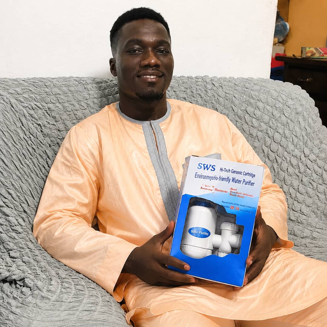 Happy customer holding his SWS water purifier package
